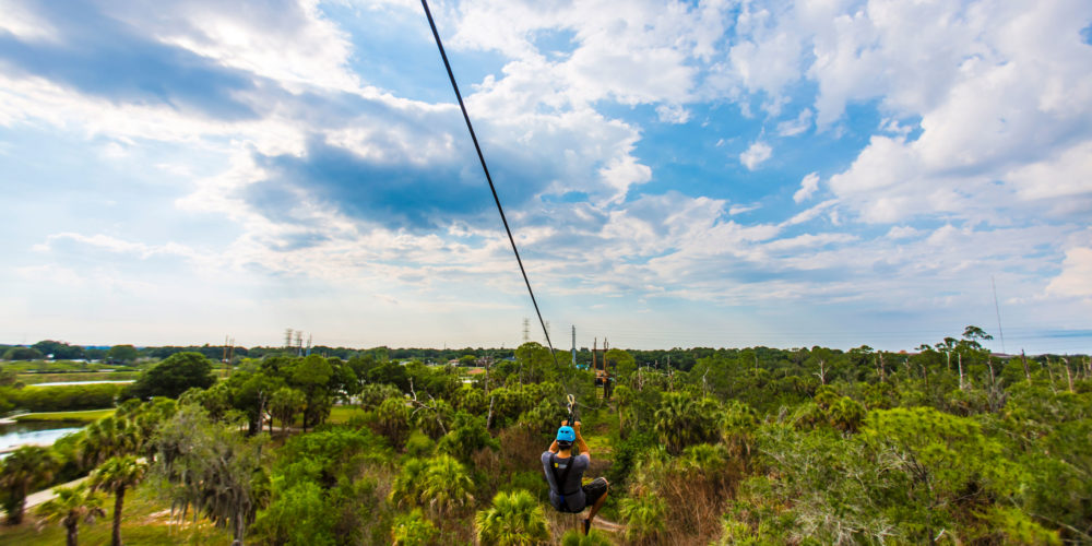 Man on a zip line course in Tampa Bay