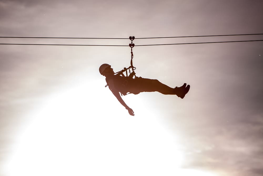 Man ziplining at Empower Adventures aerial park