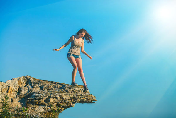 Woman standing on the edge of a cliff